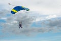 Paraglider tandem fly against the blue sky.