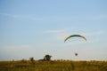 Paraglider with yellow parachute taking off Royalty Free Stock Photo