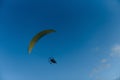 Paraglider with yellow parachute taking off Royalty Free Stock Photo