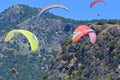 Paragliders on a blue sky and mountains background Royalty Free Stock Photo
