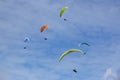 Paragliders flying in a blue sky