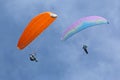 Paragliders flying in a blue sky