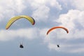 Paragliders flying in a cloudy sky