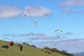 Paragliders flying from a hill