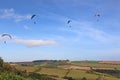 Paragliders flying from a hill