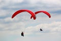 Paragliders flying red wings