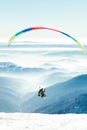 Paragliders launched into air from snowy slope of a mountain Royalty Free Stock Photo