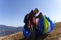 Paragliders preparing for the flight in mountain. Extreme sports activity.