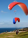 Paragliders ready to fly into the blue sky over the ocean