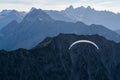 Paraglider flying above blue Mountains Silhouette, Allgaeu, Oberstdorf, Alps, Germany. Travel destination. Freedom and Royalty Free Stock Photo