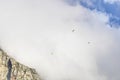 Three paragliders floating in clouds over Table Mountain, Cape Town. Royalty Free Stock Photo