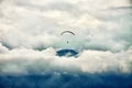 Paragliding among clouds above mountain range Royalty Free Stock Photo