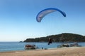 A paragliding comes in to land on Oludeniz Beach on the Turquoise Coast of Turkey.