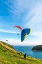 Paragliding Extreme sport, Paraglider flying on the blue sky and white cloud in Summer day at Phuket Sea, Thailand