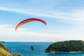 Paragliding Extreme sport, Paraglider flying on the blue sky and white cloud in Summer day at Phuket Sea, Thailand
