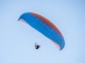 Paragliding in Oludeniz. Paraglider, airborne against blue sky.