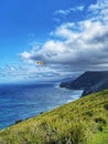 Paraglider over the ocean and cliffs Royalty Free Stock Photo