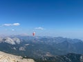 Paragliding over mountains with parachute. Paragliding behind blue sky hills range landscape. Active tourist sport People fly Royalty Free Stock Photo