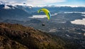 Paragliding over Nahuel Huapi lake and mountains of Bariloche in Argentina, with snowed peaks in the background. Concept of Royalty Free Stock Photo