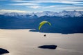 Paragliding over Nahuel Huapi lake and mountains of Bariloche in Argentina, with snowed peaks in the background. Concept of