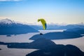 Paragliding over Nahuel Huapi lake and mountains of Bariloche in Argentina, with snowed peaks in the background. Concept of Royalty Free Stock Photo