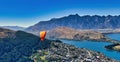 Paragliding over Queenstown New Zealand, majestic snowy mountains background, Sparkling Lake Wakatipu below Royalty Free Stock Photo