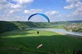 Paragliding over the river valley in summer sunny day.