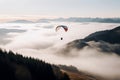 Paragliding parachute above the mist. Generate ai