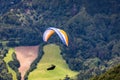 Paragliding in paradise landscape with volcano crater and lagoon in Azores. Paraglider above Lagoa das Furnas, Sao Miguel, Azores