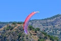 Paragliding. Paraglider on a blue sky and mountains background Royalty Free Stock Photo