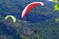 Paragliding. Paragliders on a blue sky and mountains background Royalty Free Stock Photo
