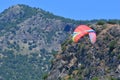 Paragliding. Paragliders on a blue sky and mountains background Royalty Free Stock Photo