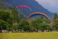 SWITZERLAND, INTERLAKEN, AUGUST 02, 2022 - Tourists paragliding in Interlaken, Bernese Oberland, Switzerland