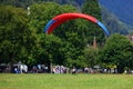 SWITZERLAND, INTERLAKEN, AUGUST 02, 2022 - Tourists paragliding in Interlaken, Bernese Oberland, Switzerland