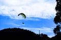 Someone paragliding against the clear day sky. Puncak, Bogor, Indonesia Royalty Free Stock Photo