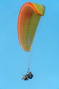 Paragliding in the sky over the sea. The concept of parachute flight. Tandem skydiver pilot and passenger fly on a sunny day Royalty Free Stock Photo