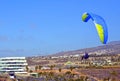 Paragliding in the sky.Paraglider flying over La Caleta village in south Tenerife island,Canary islands,Spain. Royalty Free Stock Photo