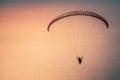 Paragliding in the sky at sunset. Paraglider flying over the Oludeniz Beach. Babadag, Fethiye, Turkey