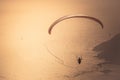 Paragliding in the sky at sunset. Paraglider flying over the Oludeniz Beach, Fethiye. Mugla, Turkey. Travel and vacation concept.
