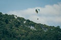 Paragliding soaring through the heights, you can see clouds, a mountain and the blue sky Royalty Free Stock Photo