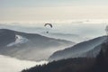 Paragliding sport parachute flying above the mist. Generate ai Royalty Free Stock Photo