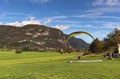 Paragliding at sunny autumn day. The Landing process. Scenic landscape view of mountain range in the background Royalty Free Stock Photo