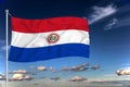 Paraguai national flag waving in the wind against deep blue sky. International relations concept