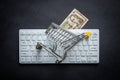 Paraguay banknote, White computer keyboard, Miniature shopping cart, Black background, Online shopping concept in stores, Low Royalty Free Stock Photo