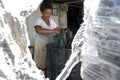 Paraguayan woman washes plastic for recycling Royalty Free Stock Photo