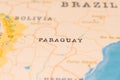 Paraguay in Focus on a Tilted World Map.
