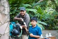 A Paraguayan boy helps his father repair a pump.