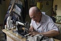 Paraguayan Senior tailor is sewing in dressmaking