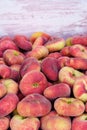 Paraguayan sweet peaches stacked in a container box to the raw for sale, cpy space Royalty Free Stock Photo