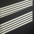 Parallel horizontal stripes of light and shadow create an abstract pattern on a dark Royalty Free Stock Photo